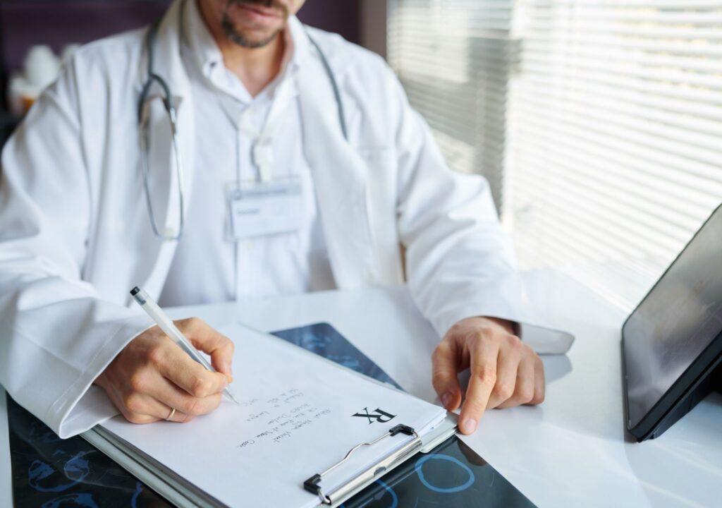 Arzt schreibt Rezept und erklärt, warum die Wirkungsdauer der Abnehmspritze von Person zu Person unterschiedlich ist – abhängig von Stoffwechsel, Körpergewicht und Dosierung